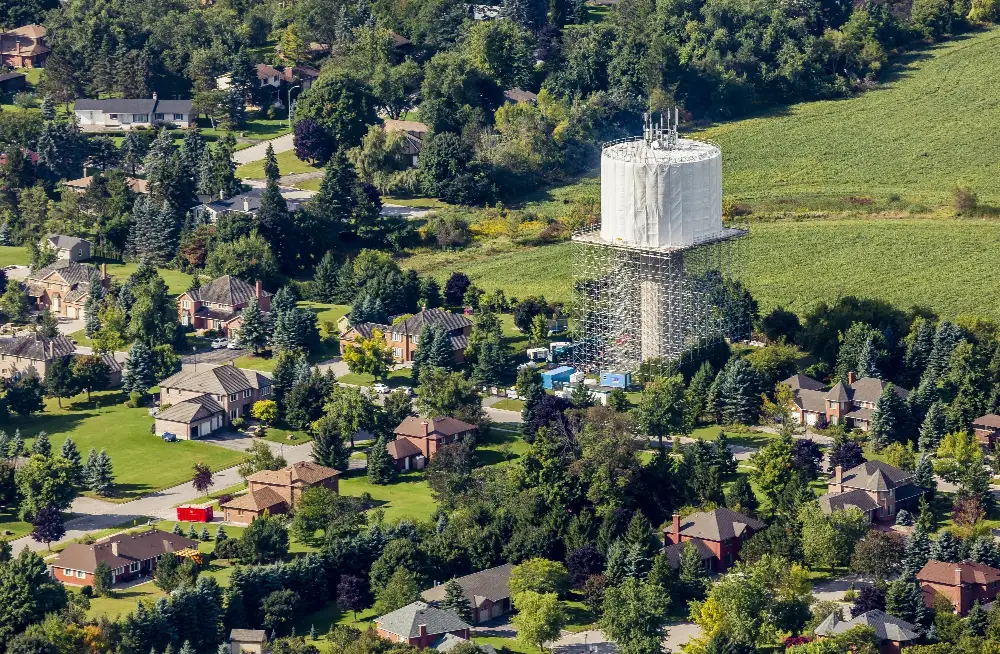 image of the surrounding neighborhood while a composite elevated water tower is being constructed.