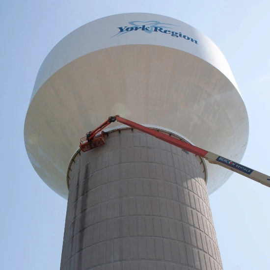 Workers adding protection to a water tower